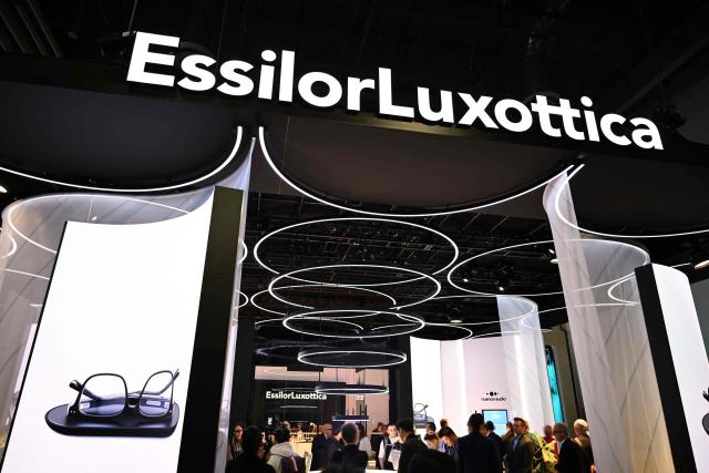 (FILES) The EssilorLuxottica SA logo is displayed at the company’s booth for the Nuance Audio OTC hearing aid glasses at the Consumer Electronics Show (CES) in Las Vegas, Nevada, on January 7, 2025. The world’s leading optics company EssilorLuxottica accelerated its growth in the second quarter, on July 28, 2026 despite "a more uncertain global macroeconomic environment," driven by its AI-enabled glasses, whose sales have nearly doubled in the space of a year. (Photo by Patrick T. Fallon / AFP)