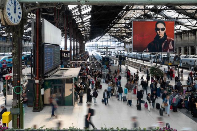 (FILES) Customers wait at Gare de Lyon railway station in Paris on May 9, 2025. SNCF posted more than one billion euros in net profit in the first half of the year, up 19%, and revenue growth of 2%, despite the impact of weather-related disruptions that affected rail traffic for four out of the six months, announced the group on July 28, 2026. (Photo by LEO VIGNAL / AFP)