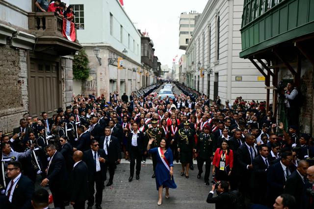 Peru's President Keiko Fujimori waves as she walks toward the Government Palace after leaving Congress following her inauguration ceremony in Lima on July 28, 2026. Fujimori took office on July 28, 2026, vowing to tackle the wave of crime sweeping the Andean nation. Fujimori won the June 7 presidential runoff by fewer than 50,000 votes, after losing the past three runoffs. (Photo by ERNESTO BENAVIDES / AFP)