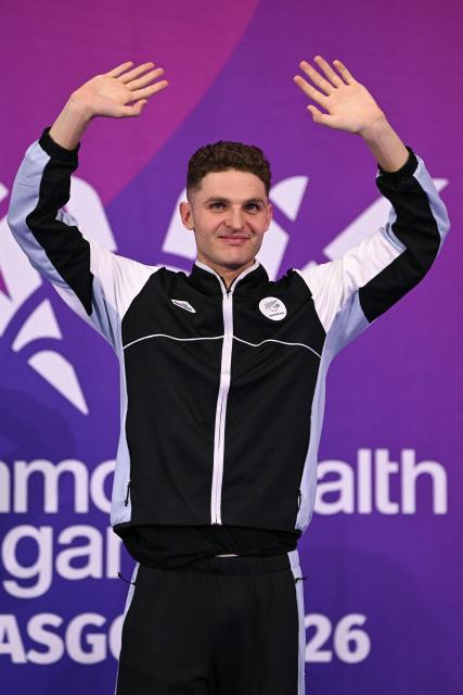 Gold medallist New Zealand's Lewis Clareburt celebrates during the Men's 400m Individual Medley Medal Ceremony at the swimming event at the Tollcross International Swimming Centre in Glasgow, on day five of the Commonwealth Games in Glasgow, Scotland, on July 28, 2026. (Photo by Oli SCARFF / AFP)