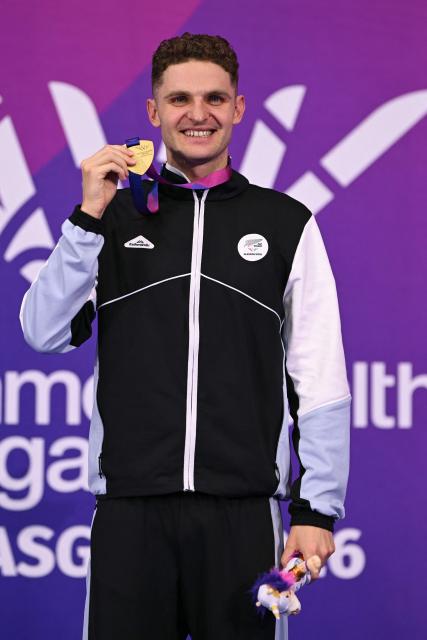Gold medallist New Zealand's Lewis Clareburt celebrates during the Men's 400m Individual Medley Medal Ceremony at the swimming event at the Tollcross International Swimming Centre in Glasgow, on day five of the Commonwealth Games in Glasgow, Scotland, on July 28, 2026. (Photo by Oli SCARFF / AFP)