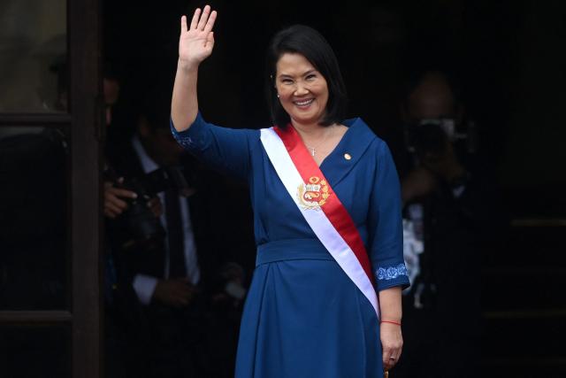 Peru's President Keiko Fujimori waves from the Government Palace following her inauguration ceremony in Lima on July 28, 2026. Fujimori took office on July 28, 2026, vowing to tackle the wave of crime sweeping the Andean nation. Fujimori won the June 7 presidential runoff by fewer than 50,000 votes, after losing the past three runoffs. (Photo by Connie FRANCE / AFP)