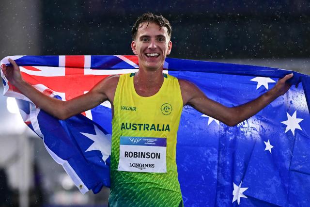 Winner Australia's Ky Robinson celebrates after competing in the men's 10,000 final during the athletics event at the Scotstoun Stadium in Glasgow, on day five of the Commonwealth Games in Glasgow, Scotland, on July 28, 2026. (Photo by Ben STANSALL / AFP)