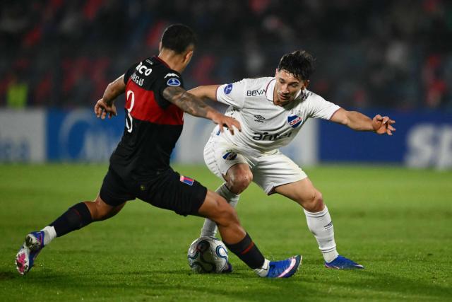 Tigre's defender #03 Nahuel Banegas (L) and Nacional's forward #11 Maximiliano Silvera fight for the ball during the second leg of the Copa Sudamericana knockout round play-off football match between Argentina's Tigre and Uruguay's Nacional at the Jose Dellagiovanna stadium in Victoria, Buenos Aires province, Argentina, on July 28, 2026. (Photo by Luis ROBAYO / AFP)