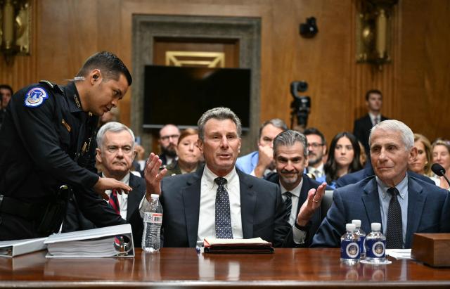 Dr. Anthony Fauci (R) looks on as his attorney David Schertler is asked to leave by a US Capitol Police officer, at the request of committee chairman Senator Rand Paul, Republican from Kentucky, during a Senate Homeland Security and Governmental Affairs committee hearing on Capitol Hill in Washington, DC, on July 29, 2026. Dr. Fauci, the former Director of the National Institute of Allergy and Infectious Diseases, is testifying after Senator Rand Paul, Republican from Kentucky, released more than 1000 pages of Fauci's diary entries from the COVID-19 pandemic. (Photo by Alex WROBLEWSKI / AFP)