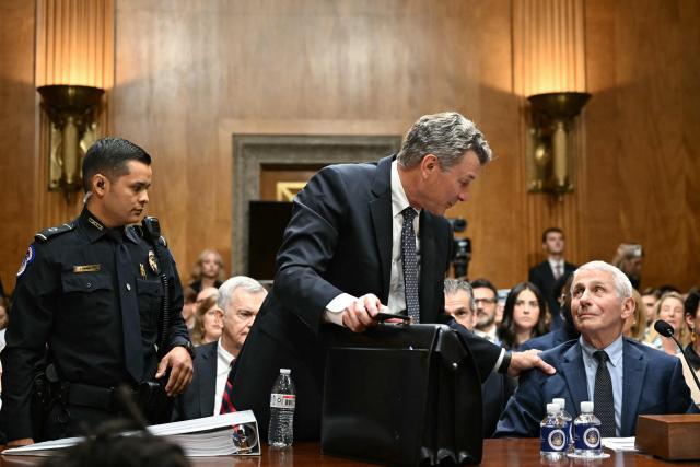 Dr. Anthony Fauci (R) looks on as his attorney David Schertler is asked to leave by a US Capitol Police officer, at the request of committee chairman Senator Rand Paul, Republican from Kentucky, during a Senate Homeland Security and Governmental Affairs committee hearing on Capitol Hill in Washington, DC, on July 29, 2026. Dr. Fauci, the former Director of the National Institute of Allergy and Infectious Diseases, is testifying after Senator Rand Paul, Republican from Kentucky, released more than 1000 pages of Fauci's diary entries from the COVID-19 pandemic. (Photo by Alex WROBLEWSKI / AFP)