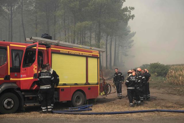Firefighters take a break as they tackle a wildfire near Lanton, east of the Arcachon Bay, west of Bordeaux on July 29, 2026, during wildfires in the Gironde region, southwestern France. The Gironde and neighbouring Landes departments are under an orange-level warning from midday on July 29, with inland temperatures of 41C forecast and 38C on the coast. (Photo by Ed JONES / AFP)