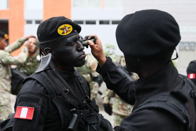Members of the Armed Forces paint their faces as they prepare to take part in a military parade to celebrate Peru's National Holidays, in Lima on July 29, 2026. Peru's conservative President Keiko Fujimori, who took office on July 28, 2026, will attend the event. (Photo by Connie FRANCE / AFP)