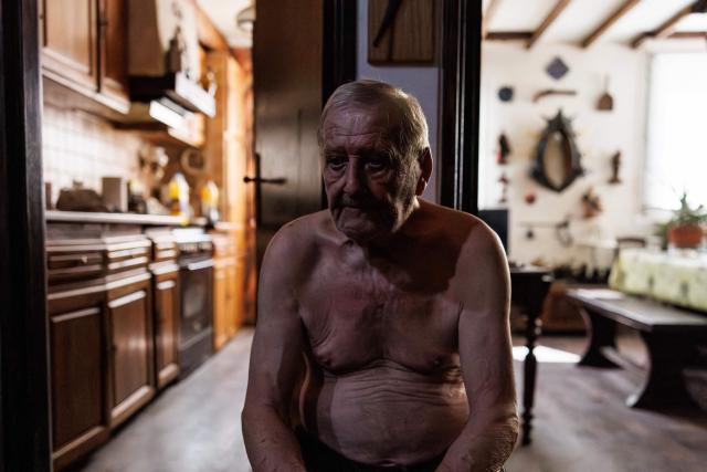 Daniel Molignier, 80, sits in the entrance of his apartment to escape the heat from the living room in his apartment at Place des Fêtes during a hot summer day in Paris on July 29, 2026. The retired couple say their home turns into a "thermal kettle" during heatwaves, becoming unbearably hot. Western Europe this year experienced its hottest June on record as a searing heatwave swept across a continent facing increasingly frequent and intense heat extremes, the EU's climate monitor said on July 9, 2026. (Photo by Simon WOHLFAHRT / AFP)