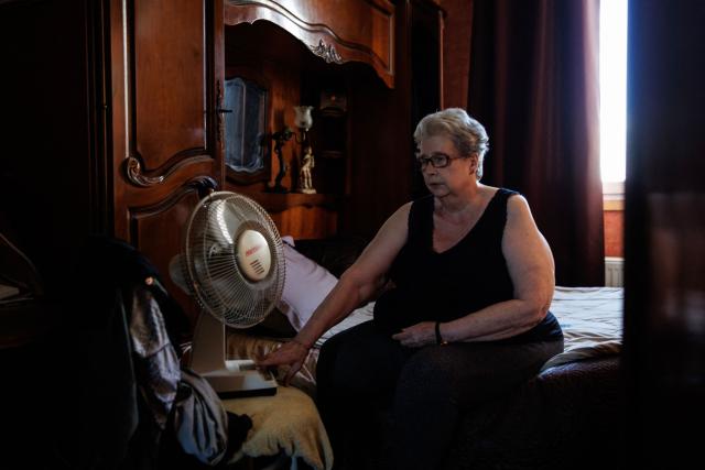 Chantal Molignier, 76, turns on the fan in a bedroom of her apartment at Place des Fêtes during a hot summer day in Paris on July 29, 2026. The retired couple say their home turns into a "thermal kettle" during heatwaves, becoming unbearably hot. Western Europe this year experienced its hottest June on record as a searing heatwave swept across a continent facing increasingly frequent and intense heat extremes, the EU's climate monitor said on July 9, 2026. (Photo by Simon WOHLFAHRT / AFP)