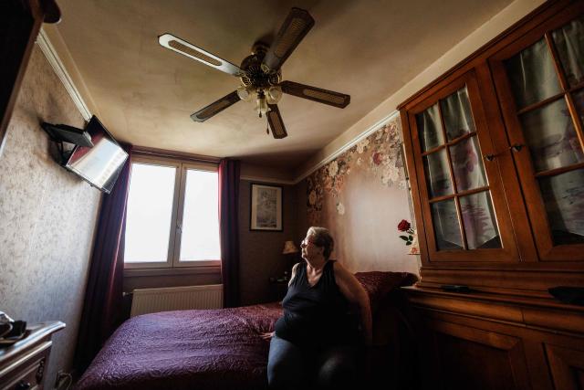 Chantal Molignier, 76, sits in the bedroom of her apartment at Place des Fêtes in Paris during a hot summer day in Paris on July 29, 2026. The retired couple say their home turns into a "thermal kettle" during heatwaves, becoming unbearably hot. Western Europe this year experienced its hottest June on record as a searing heatwave swept across a continent facing increasingly frequent and intense heat extremes, the EU's climate monitor said on July 9, 2026. (Photo by Simon WOHLFAHRT / AFP)
