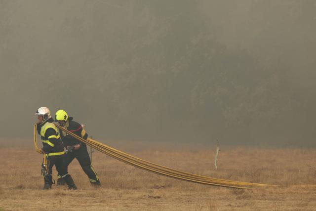 Firefighters take part in operations against a wildfire near Lanton, southwestern France, on July 29, 2026. The return of intense heat on July 29, 2026, and sea winds are fanning the megafire in Gironde, with new flare-ups in places after a second, calmer night that had made it possible to “stabilize” the blaze. Forests catch fire all the more easily because the vegetation and soil have been extremely dry for months, a drought worsened by climate change and the recent exceptional heatwaves. (Photo by Alain JOCARD / AFP)