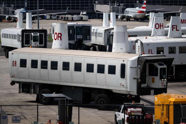 A mobile lounge vehicle, colloquially called a "people-mover," is seen moving to a parking area at Washington Dulles International Airport (IAD) in Dulles, Virginia, on July 29, 2026. US President Donald Trump unveiled on Wednesday a $20 billion plan to rebuild and renovate Washington Dulles International Airport. (Photo by Kent Nishimura / AFP)