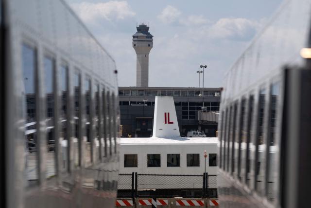 A mobile lounge vehicle, colloquially called a "people-mover," is seen moving between terminals at Washington Dulles International Airport (IAD) in Dulles, Virginia, on July 29, 2026. US President Donald Trump is set to unveil on Wednesday a $20 billion plan to rebuild and renovate Washington Dulles International Airport. (Photo by Kent Nishimura / AFP)