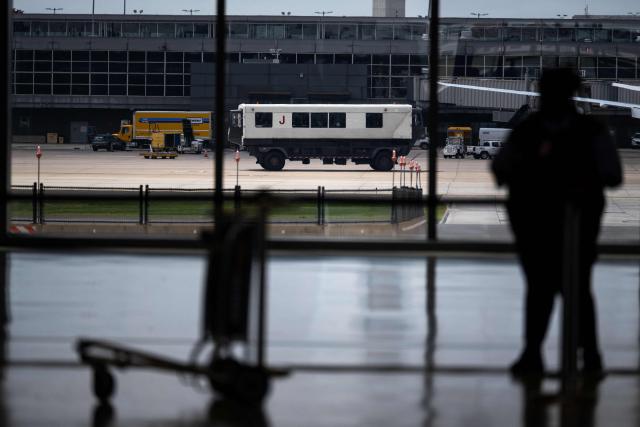 A mobile lounge vehicle, colloquially called a "people-mover," is seen moving between terminals at Washington Dulles International Airport (IAD) in Dulles, Virginia, on July 29, 2026. US President Donald Trump is set to unveil on Wednesday a $20 billion plan to rebuild and renovate Washington Dulles International Airport. (Photo by Kent Nishimura / AFP)