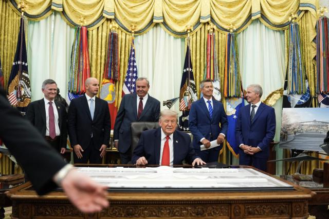 US President Donald Trump blinks an eye at the end of an announcement about Dulles International Airport renovations with Secretary of Transportation Sean Duffy (2R) in the Oval Office of the White House in Washington, DC on July 29, 2026. US President Donald Trump is set to unveil a $20 billion plan to rebuild and renovate Washington Dulles International Airport. (Photo by Ken Cedeno / AFP)