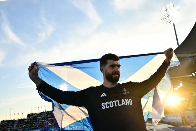 Third-placed Scotland's Stephen Mackenzie celebrates after competing in the men's long jump final during the athletics event at the Scotstoun Stadium in Glasgow, on day six of the Commonwealth Games in Glasgow, Scotland, on July 29, 2026. (Photo by Ben STANSALL / AFP)