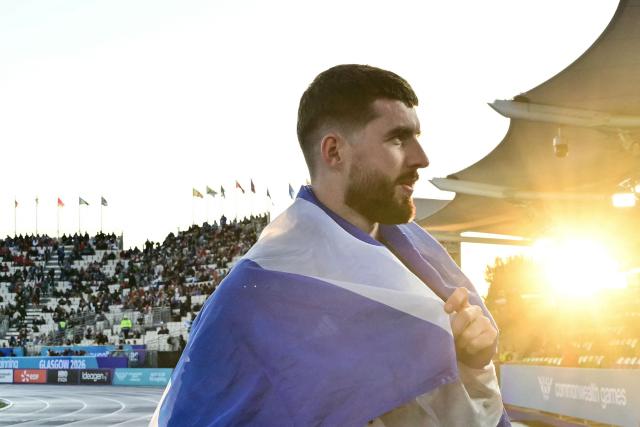 Third-placed Scotland's Stephen Mackenzie celebrates after competing in the men's long jump final during the athletics event at the Scotstoun Stadium in Glasgow, on day six of the Commonwealth Games in Glasgow, Scotland, on July 29, 2026. (Photo by Ben STANSALL / AFP)