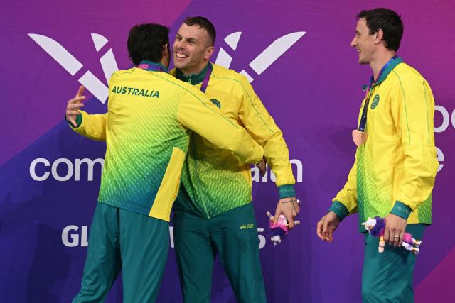 Joint gold medallists Australia's Ben Armbruster (L) and Kyle Chalmers celebrate with bronze medalist Australia's Cameron McEvoy during the Men's 50m Butterfly Medal Ceremony at the swimming event at the Tollcross International Swimming Centre in Glasgow, on day six of the Commonwealth Games in Glasgow, Scotland, on July 29, 2026. (Photo by Oli SCARFF / AFP)