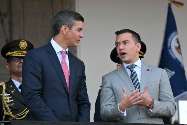 Paraguay's President Santiago Pena (L) chats with Ecuador's President Daniel Noboa as they watch the changing of the guard at the Carondelet Palace in Quito on July 29, 2026. (Photo by Rodrigo BUENDIA / AFP)