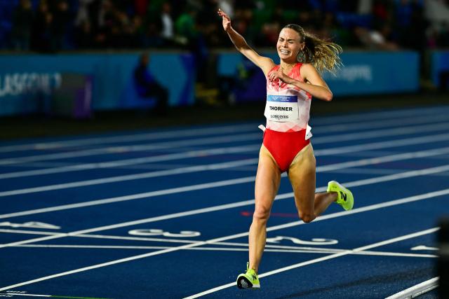Second-placed England's Elise Thorner celebrates as she crosses the finish line in the women's 3000m steeplechase final during the athletics event at the Scotstoun Stadium in Glasgow, on day six of the Commonwealth Games in Glasgow, Scotland, on July 29, 2026. (Photo by Ben STANSALL / AFP)