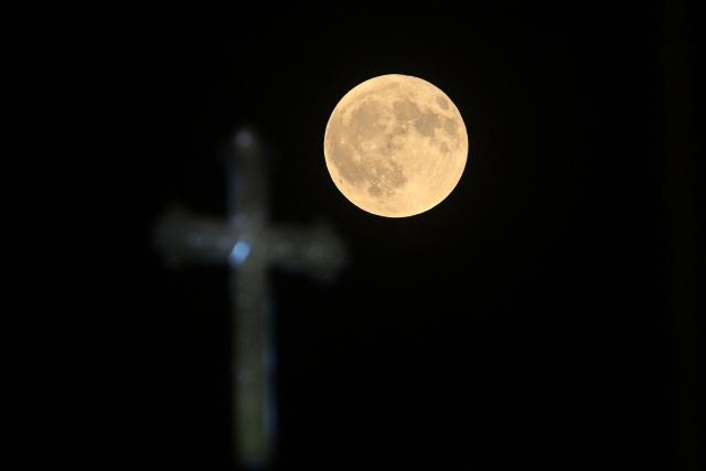 The full moon, known as the Buck Moon, rises over the Church of St. John the Baptist in Skopje on July 29, 2026. (Photo by Robert ATANASOVSKI / AFP)