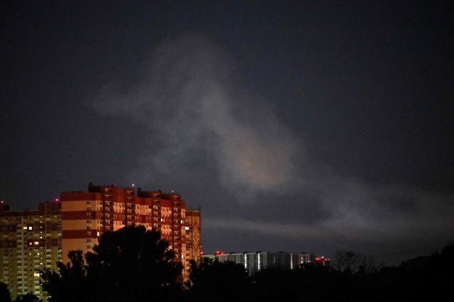 The photograph shows smoke in the sky following Russian ballistic missile strikes over the Ukrainian capital of Kyiv on July 30, 2026, amid the Russian invasion in Ukraine. Explosions were heard in Kyiv, an AFP journalist said, after President Volodymyr Zelensky said Russia would likely carry out another massive attack overnight. (Photo by Sergei SUPINSKY / AFP)