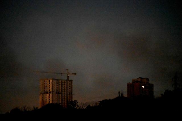 The photograph shows smoke in the sky following Russian ballistic missile strikes over the Ukrainian capital of Kyiv on July 30, 2026, amid the Russian invasion in Ukraine. Explosions were heard in Kyiv, an AFP journalist said, after President Volodymyr Zelensky said Russia would likely carry out another massive attack overnight. (Photo by Sergei SUPINSKY / AFP)