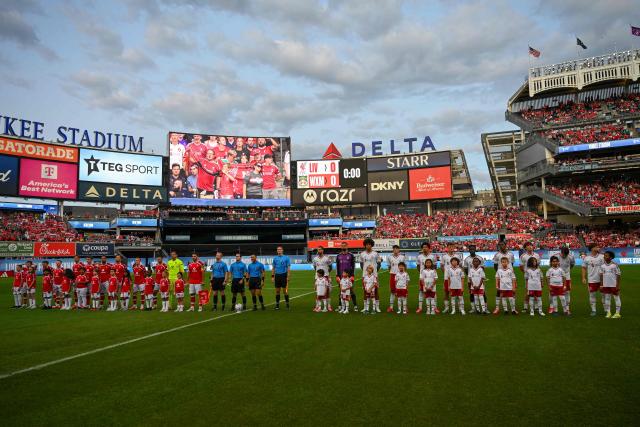 Wrexham (L) and Liverpool players stand on the pitch ahead of the friendly football match between Liverpool and Wrexham at Yankee Stadium in New York, on July 29, 2026. (Photo by Angela WEISS / AFP)