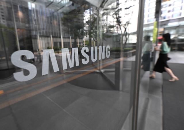 The logo of Samsung is seen at the Samsung Electronics Seocho building in Seoul on July 30, 2026. South Korean technology giant Samsung Electronics posted on July 30, a massive 19-fold jump in second-quarter operating profit from a year earlier, buoyed by sustained AI-driven demand for memory chips. (Photo by Jung Yeon-je / AFP)