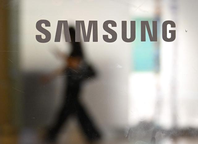 The logo of Samsung is seen at the Samsung Electronics Seocho building in Seoul on July 30, 2026. South Korean technology giant Samsung Electronics posted on July 30, a massive 19-fold jump in second-quarter operating profit from a year earlier, buoyed by sustained AI-driven demand for memory chips. (Photo by Jung Yeon-je / AFP)