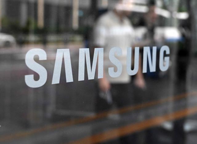 The logo of Samsung is seen at the Samsung Electronics Seocho building in Seoul on July 30, 2026. South Korean technology giant Samsung Electronics posted on July 30, a massive 19-fold jump in second-quarter operating profit from a year earlier, buoyed by sustained AI-driven demand for memory chips. (Photo by Jung Yeon-je / AFP)