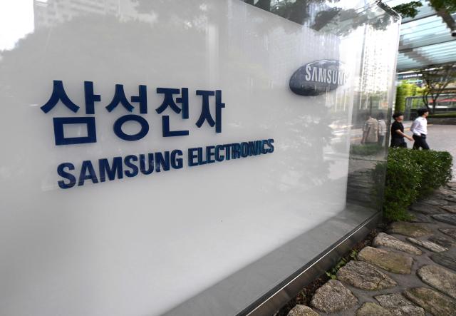 Signage of Samsung Electronics is displayed outside the company's Seocho building in Seoul on July 30, 2026. South Korean technology giant Samsung Electronics posted on July 30, a massive 19-fold jump in second-quarter operating profit from a year earlier, buoyed by sustained AI-driven demand for memory chips. (Photo by Jung Yeon-je / AFP)