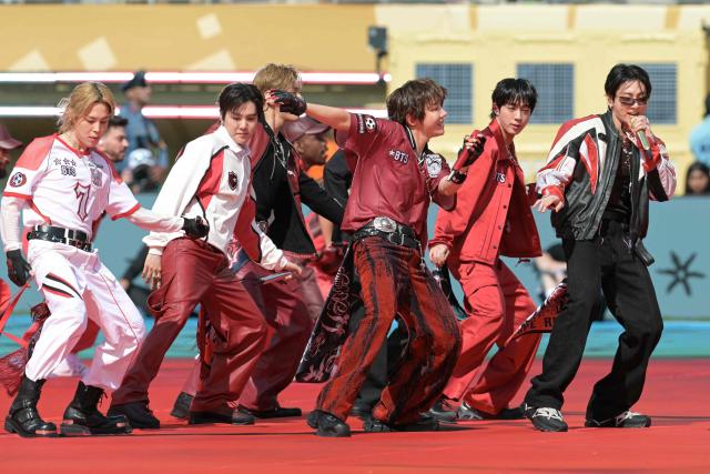 (FILES) Members of the South Korean boy band BTS perform during the 2026 World Cup football tournament final match between Spain and Argentina at the New York/New Jersey Stadium in East Rutherford on July 19, 2026. Global K-pop sensation BTS said on July 29, 2026, they will not submit their music for next year's Grammy Awards, after the Recording Academy introduced a new Asian pop category criticised for restricting the success of regional artists. (Photo by JUAN MABROMATA / AFP)