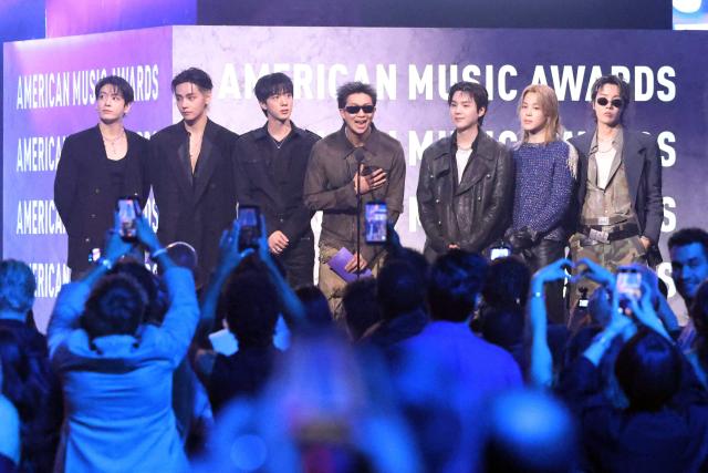 (FILES) South Korean boy band BTS presents an award on stage during the American Music Awards at the MGM Grand Garden Arena in Las Vegas, Nevada on May 25, 2026. Global K-pop sensation BTS said on July 29, 2026, they will not submit their music for next year's Grammy Awards, after the Recording Academy introduced a new Asian pop category criticised for restricting the success of regional artists. (Photo by VALERIE MACON / AFP)