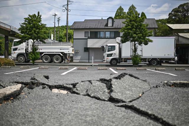 A cracked road is seen in Hikawa, Kumamoto Prefecture on July 30, 2026, after an earthquake struck southwestern Japan on July 28. (Photo by Philip FONG / AFP)