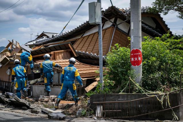 Rescue officials work at the site of a house that collapsed following the 28 July earthquake in Yatsushiro, Kumamoto prefecture on 30 July 2026. (Photo by Yuichi YAMAZAKI / AFP)