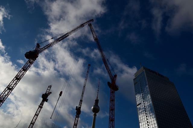 (FILES) Clouds cover the sky as cranes operate at a building and construction site close to the TV tower (C) and Park Inn Hotel (R) at Alexanderplatz square in Berlin, Germany on November 22, 2024. German economic growth slowed in the second quarter but less than expected given the impact of the Middle East war, according to provisional figures released on July 30, 2026. Output in the EU's top economy rose 0.2 percent compared with the first three months of the year, statistics office Destatis said, 0.1 percentage point higher than predicted by analysts polled by financial platform FactSet. (Photo by Tobias SCHWARZ / AFP)