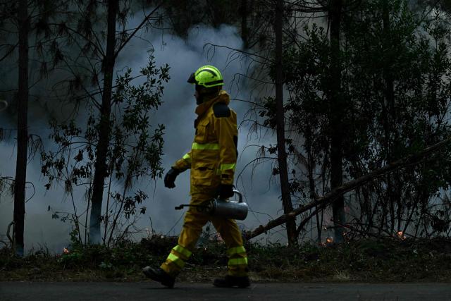 A firefighter holds a metal drip torch to ignite controlled fires in a forest in Le Porge, north of the Arcachon Basin, on July 30, 2026, during wildfires in the Gironde region, southwestern France. In France, the Gironde region reported a second calm night and said the massive fire west of France's wine-making capital of Bordeaux remained stable despite a spike in temperatures on July 29 as the fourth heatwave of the summer roasted the area. (Photo by Philippe Lopez / AFP)