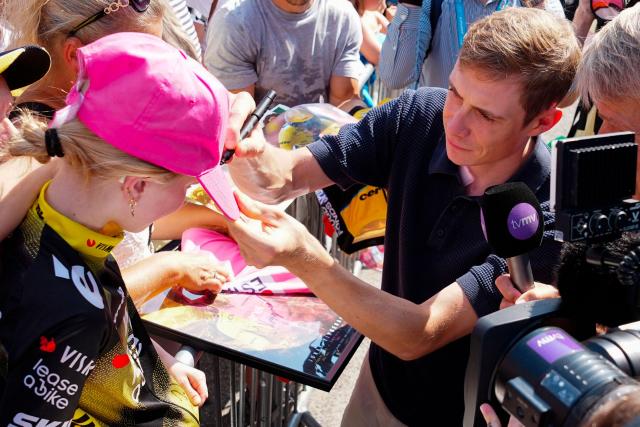 Danish racing cyclist Jonas Vingegaard (R) signs autographs for fans in Glyngoere, Denmark on July 30, 2026 during the second stage of the PostNord Denmark Tour. The stage is 187.2 kilometers long and will run from Glyngoere to Skive on July 30, 2026. (Photo by Henning Bagger / Ritzau Scanpix / AFP) / Denmark OUT