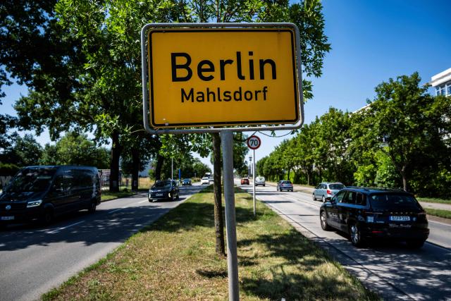 Cars drive past a road sign indicating the city of Berlin's boundary with Brandenburg, in Berlin's Mahlsdorf locality, on July 30, 2026. The German capital's boundaries date back to October 1, 1920 when the Greater Berlin Act came into effect, expanding Berlin's area overnight from 66 square kilometers to nearly 880 square kilometers. (Photo by John MACDOUGALL / AFP)