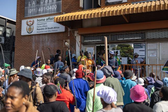 Protesters gather outside the Department of Home Affairs offices during a demonstration calling for the removal of undocumented immigrants in Alexandra township on July 30, 2026. South African President Cyril Ramaphosa called on July 27 for African countries to work together to manage migration, as his government faces mounting pressure over attacks on foreign nationals. Ramaphosa's appeal to the Pan-African Parliament follows weeks of anti-migrant protests in South Africa, where xenophobic activists and fringe groups have blamed undocumented migrants from elsewhere in Africa for crime, unemployment and strain on public services. (Photo by EMMANUEL CROSET / AFP)