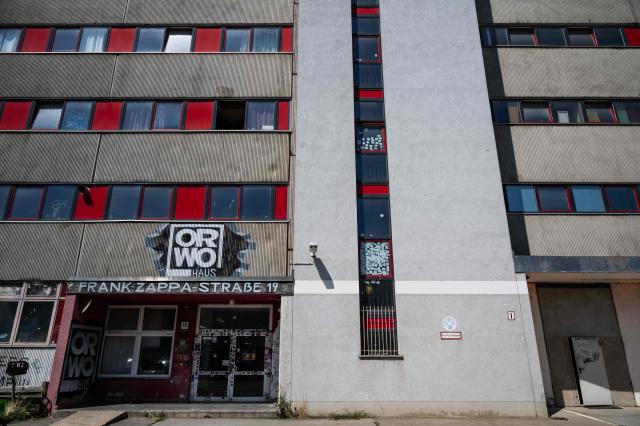 View of the entrance to the building ORWO Haus music collective taken on July 30, 2026 and located in the Frank-Zappa-Strasse in Berlin. Located in a building that used to house offices for the East German film manufacturer ORWO, the collective offers rehearsal studios and other services for musicians. (Photo by John MACDOUGALL / AFP)
