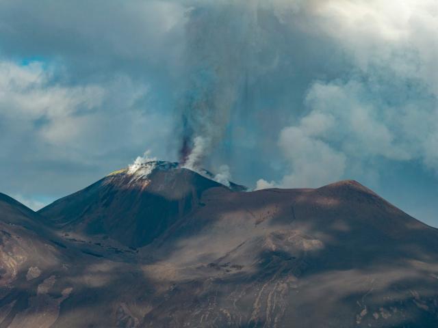 A plum of ashes rises from a crater of the Mount Etna volcano during an eruption on July 30, 2026. (Photo by Giuseppe Distefano / Etna Walk / AFP)
