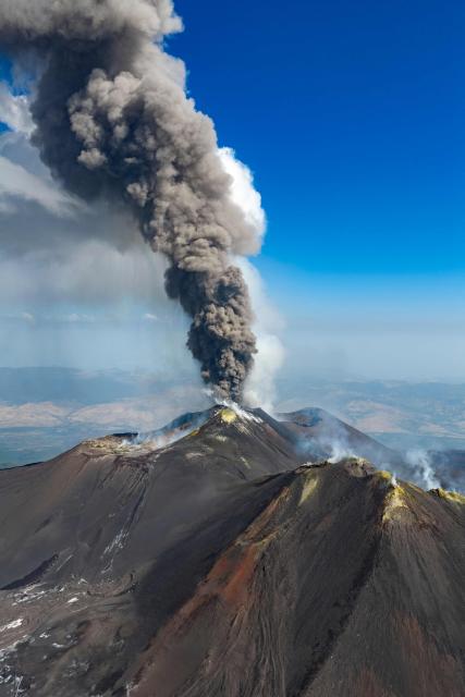A plum of ashes rises from a crater of the Mount Etna volcano during an eruption on July 30, 2026. (Photo by Giuseppe Distefano / Etna Walk / AFP)