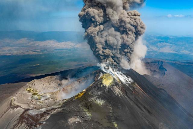 A plum of ashes rises from a crater of the Mount Etna volcano during an eruption on July 30, 2026. (Photo by Giuseppe Distefano / Etna Walk / AFP)