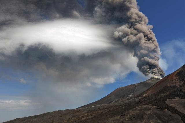A plum of ashes rises from a crater of the Mount Etna volcano during an eruption on July 30, 2026. (Photo by Giuseppe Distefano / Etna Walk / AFP)