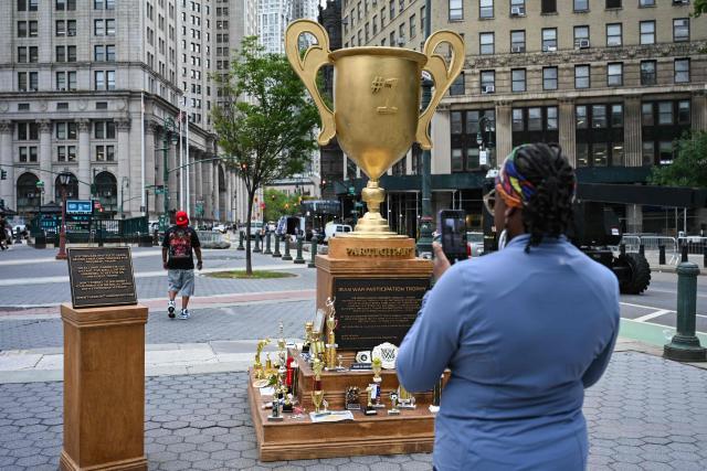 A satirical "Iran War Participation Trophy" is seen in Lower Manhattan in New York City on July 30, 2026. The satirical work is the latest installment by a group of anonymous artists that aim to mock US President Donald Trump. (Photo by Angela WEISS / AFP)