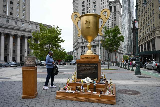 A satirical "Iran War Participation Trophy" is seen in Lower Manhattan in New York City on July 30, 2026. The satirical work is the latest installment by a group of anonymous artists that aim to mock US President Donald Trump. (Photo by Angela WEISS / AFP)