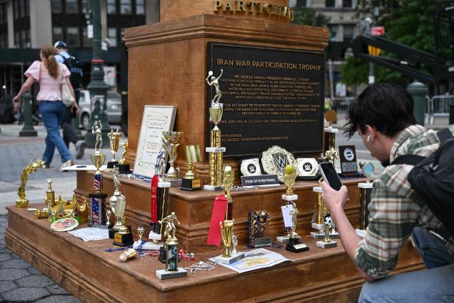 A satirical "Iran War Participation Trophy" is seen in Lower Manhattan in New York City on July 30, 2026. The satirical work is the latest installment by a group of anonymous artists that aim to mock US President Donald Trump. (Photo by Angela WEISS / AFP)